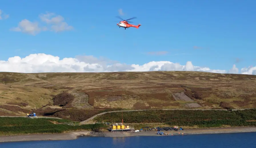 Selwood pump being delivered by helicopter at Walshaw Dean reservoir, organised by Selwood's Leeds depot