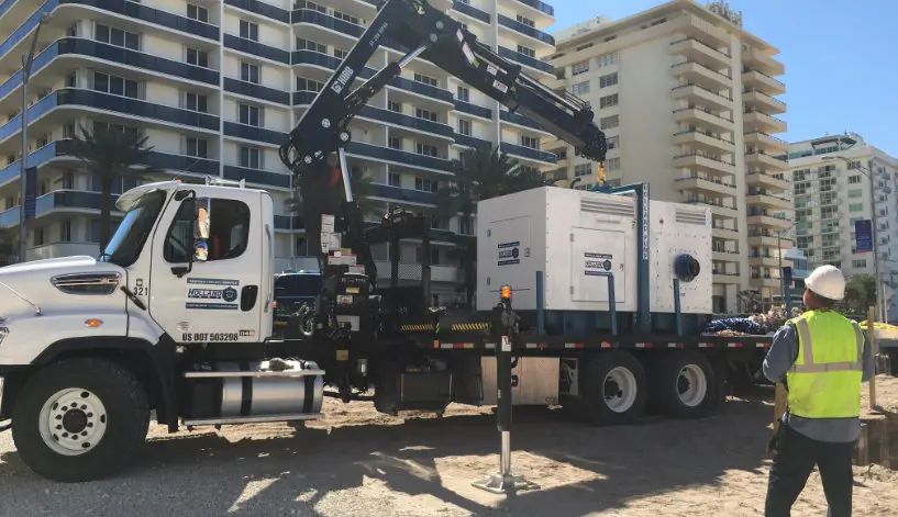 A Holland Pump employee helping deploy a pump for a municipal project
