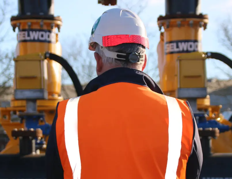 The back of a Selwood employee as he works on a pump installation