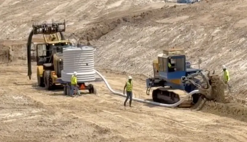 Holland Pump Sock Dewatering Trencher on site