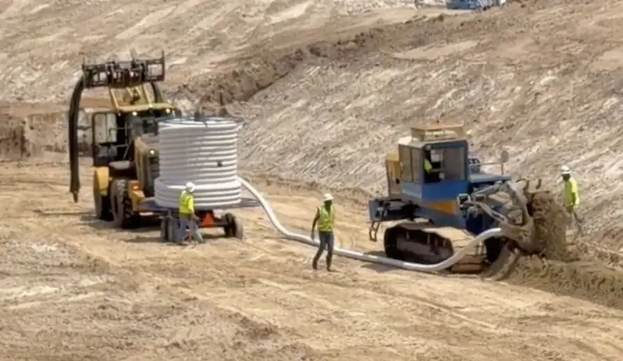 Holland Pump Sock Dewatering Trencher on site