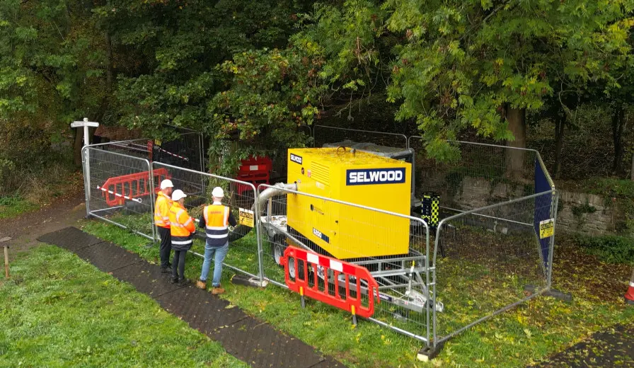 Selwood Weymouth depot deploying a pump on hire in Somerset alongside a footpath and river
